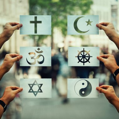 Religion conflicts as global issue concept. Human hands holding different paper with faith symbols over crowded street scene. Relations between different people doctrines and beliefs, social problem. clipart