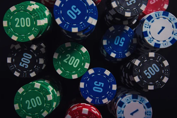 Close up stack of different colored poker chips of diverse value