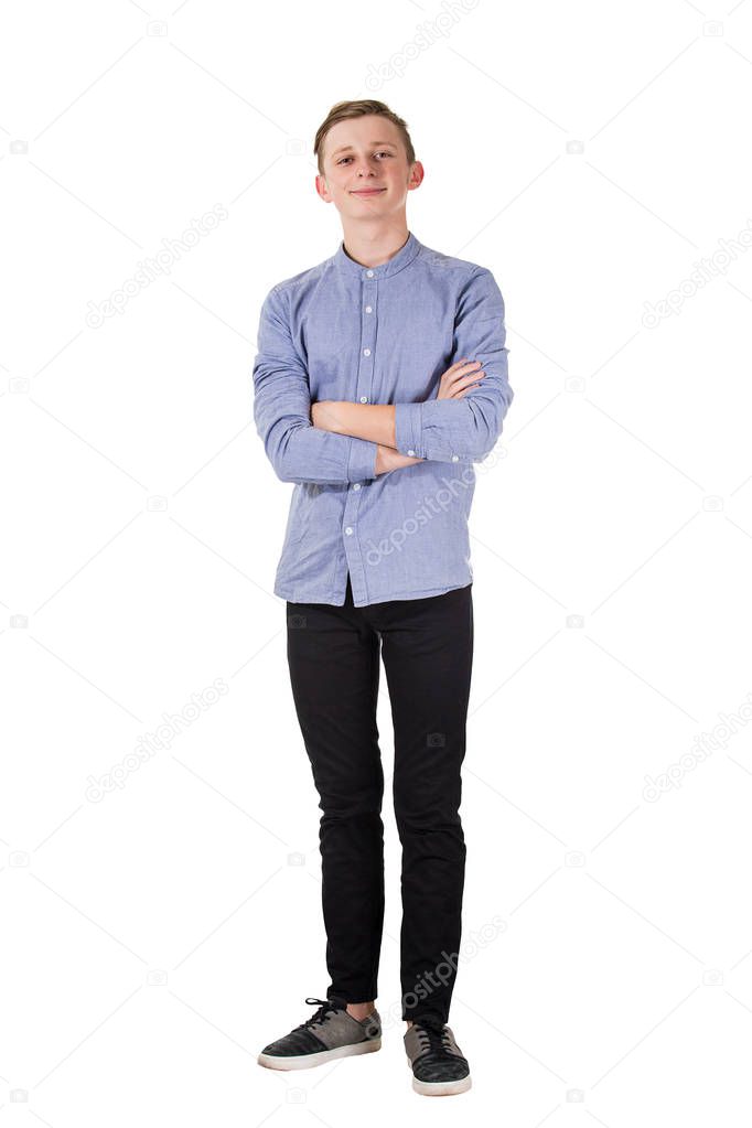 Full length portrait of casual, confident teenage boy posing wit
