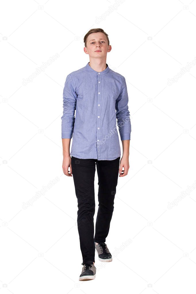 Full length portrait of casual teenage boy confident walking tow