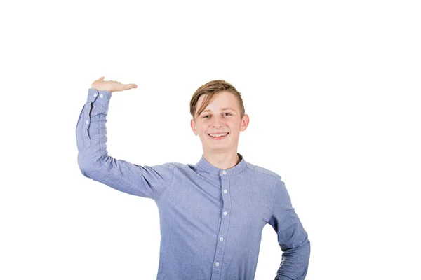 Cheerful teenage boy keeps arm up like holding something invisib — Stock Photo, Image