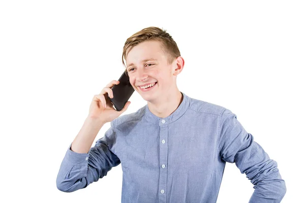 Joyful teenage guy talking with someone on his mobile phone isol — Stock Photo, Image
