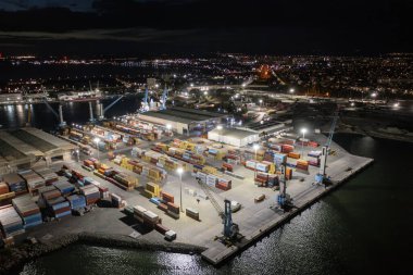 Aerial view to a container unloading terminal of port of Burgas, Bulgaria at night. Logistics and transport