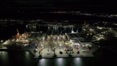 Aerial view to a container unloading terminal of port of Burgas, Bulgaria at night. Logistics and transport