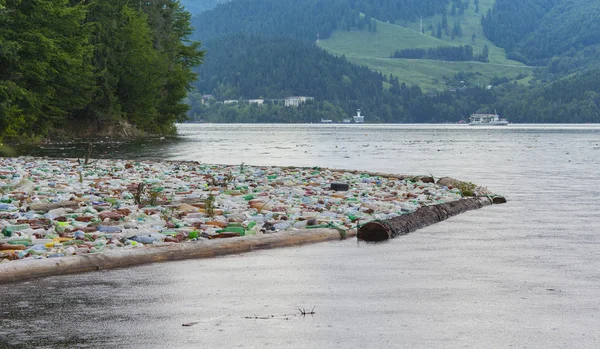 lake pollution with plastic bags in the water