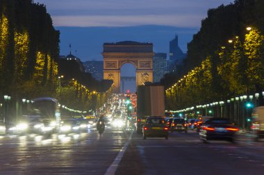 Paris şehri günbatımı sahnede. Arc de Triomphe, Champs Elysees Bulvarı yakınındaki sokak trafik uzun pozlama fotoğraf.