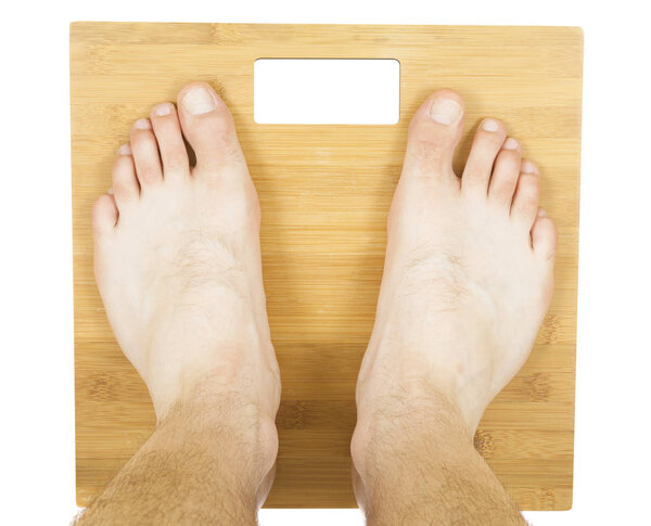 man feet on the scale. isolated on white