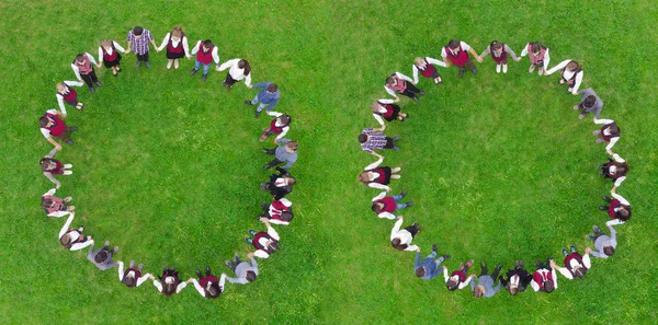 children holding hands in circle. green meadow scene, aerial view