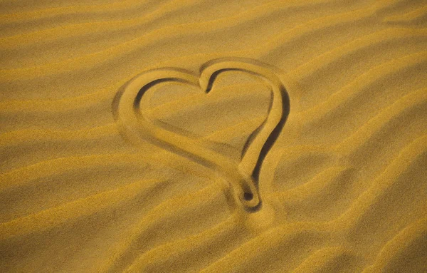 drawing of romantic heart in the arabic sand desert. love concept