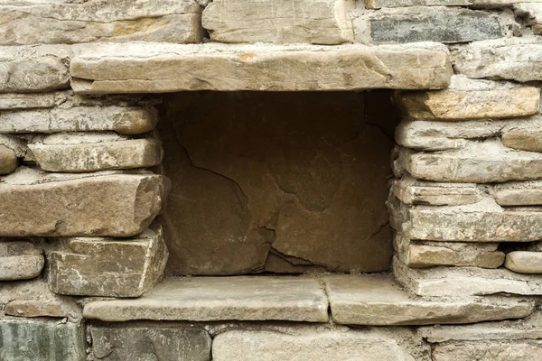 stone wall with hole for deposit in the basement