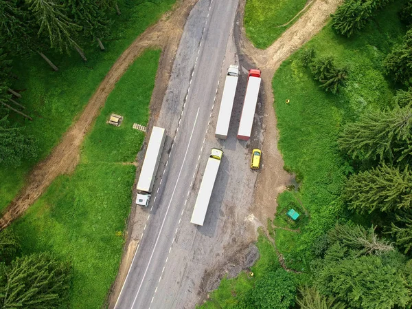 trucks in a paking in the forest. Aerial view