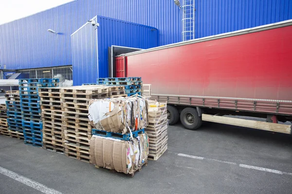 red truck discharging goods in warehouse. transportation concept