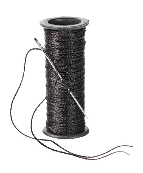 spool of black thread on white isolated background