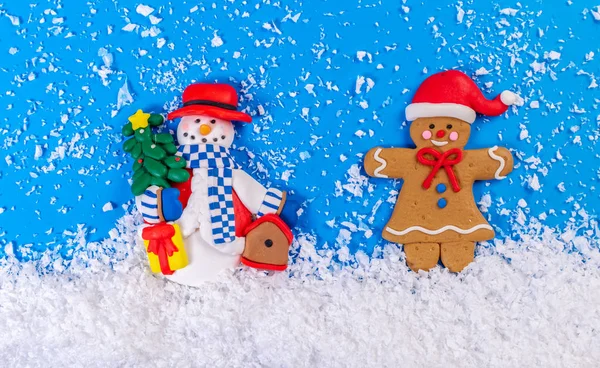 snowman and ginger man in the snow, festive background