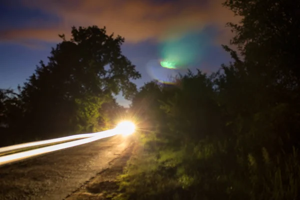 Strong light car trail on blurred street, long exposure