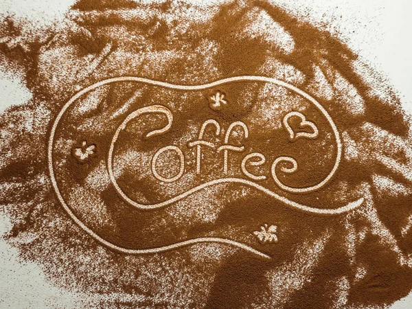 Word coffee handwrite in coffee powder on white textured backgro — Stock Photo, Image