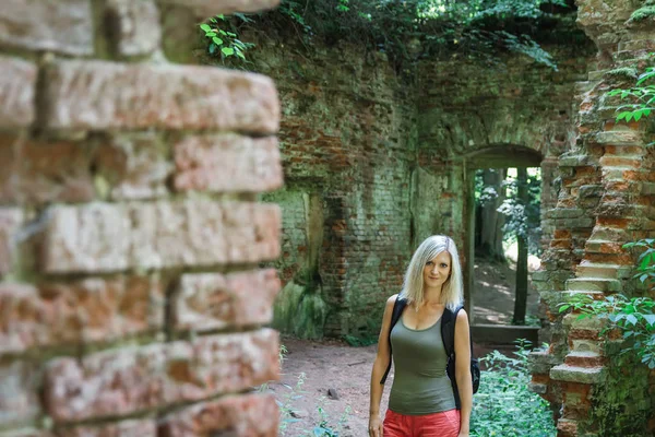 Portrait of Caucasian blonde woman in old building ruin, Czech repubic