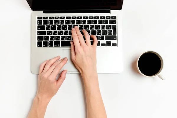 Woman typing on laptop. Workspace laptop and mug of coffee on a white background