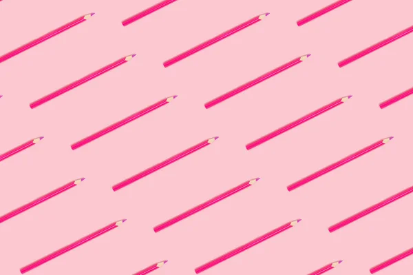 Pink pencils pattern on a pastel background. Monochrome creative layout.
