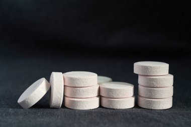 siyah Tekstil zemin üzerine beyaz hap yığını. Sağlık Eczanesi