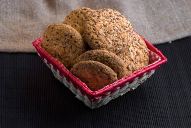 Tuzlu kurabiye üzerinde bir ahşap masa ve çuval bezi arka plan ayçiçeği susam serpilir