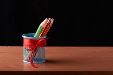 Boya kalemi siyah arka plan üzerine sınıfta fincan ile masaüstü