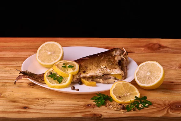 Otlar ve ahşap zemin, üstten görünüm üzerine limon ile ızgara balık. Akdeniz lüks deniz ürünleri kavramı