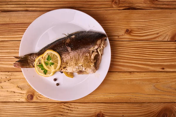 Baked Fish Lemon Spices Herbs White Plate Wooden Background — Stock Photo, Image