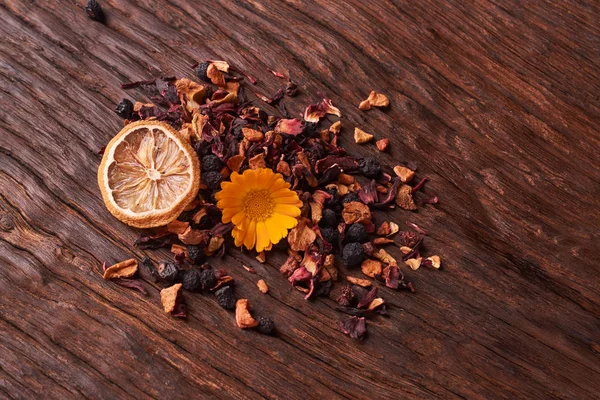 Siyah Kuru meyve çayı üzerinde ahşap masa bırakır. Seçici odak