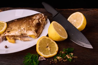 Otlar ve ahşap zemin, üstten görünüm üzerine limon ile ızgara balık. Akdeniz lüks deniz ürünleri kavramı