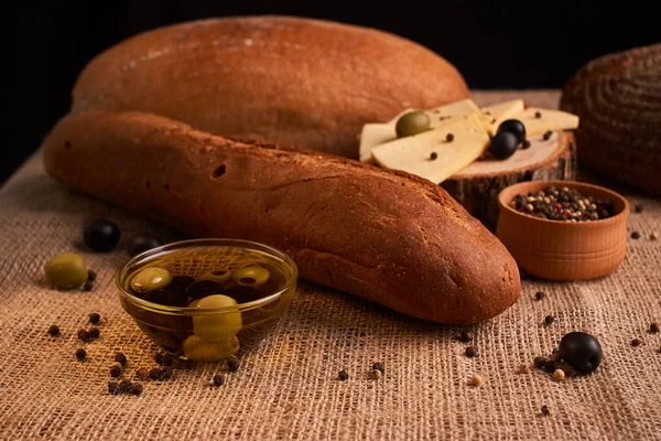 Fresh Italian baguette on wooden table with oil.Selective and soft focus — Stock Photo, Image