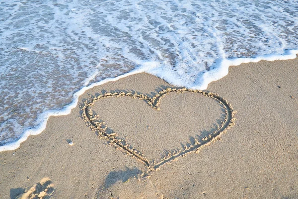 Love message on the beach sand - vacation and travel concep Stock Image