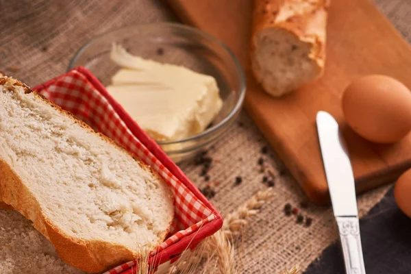 Different bread and wheat on the rustic table. Selective focus, close up — Stock Photo, Image