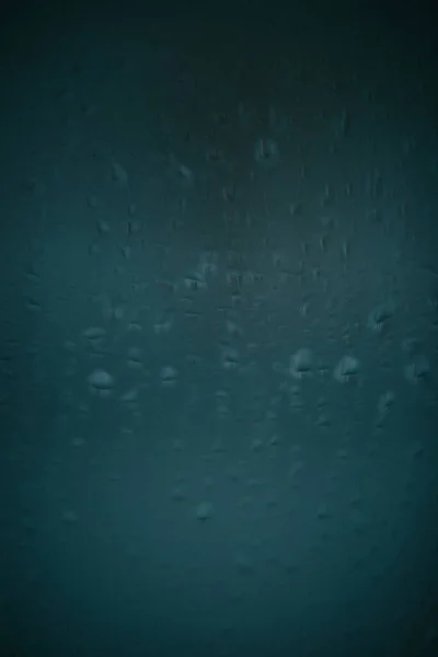 Raindrops on window glass,condensation on the window,natural background,color texture,abstract and pattern