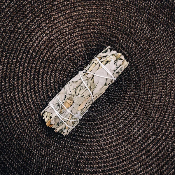 Natural incense White Sage and Palo Santo. Sacred tree of South America, color square photo.White Sage and Palo Santo on white background.