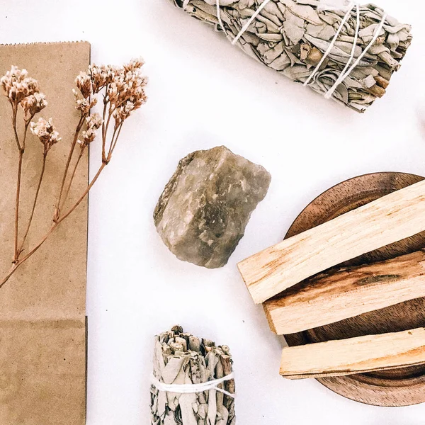 Natural incense White Sage and Palo Santo. Sacred tree of South America, color square photo.White Sage and Palo Santo on white background.