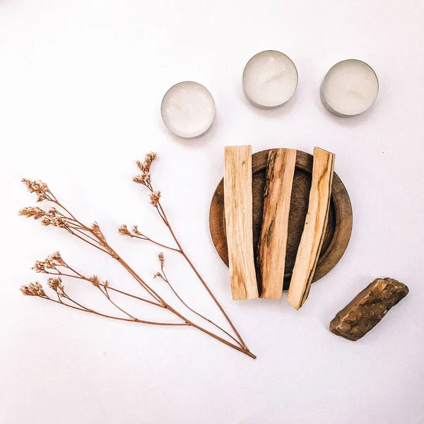 Natural incense White Sage and Palo Santo. Sacred tree of South America, color square photo.White Sage and Palo Santo on white background.