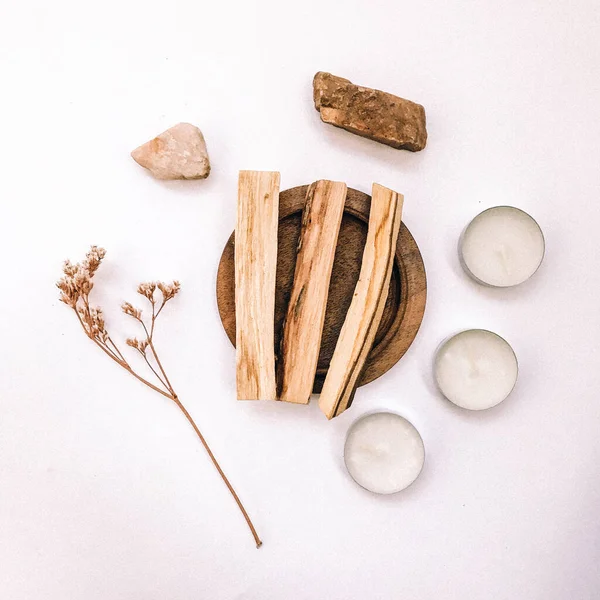 Natural incense White Sage and Palo Santo. Sacred tree of South America, color square photo.White Sage and Palo Santo on white background.