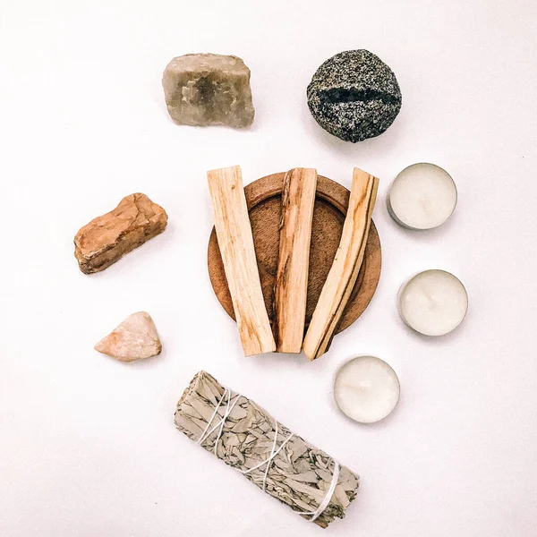 Natural incense White Sage and Palo Santo. Sacred tree of South America, color square photo.White Sage and Palo Santo on white background.