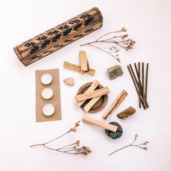 Natural incense White Sage and Palo Santo. Sacred tree of South America, color square photo.White Sage and Palo Santo on white background.