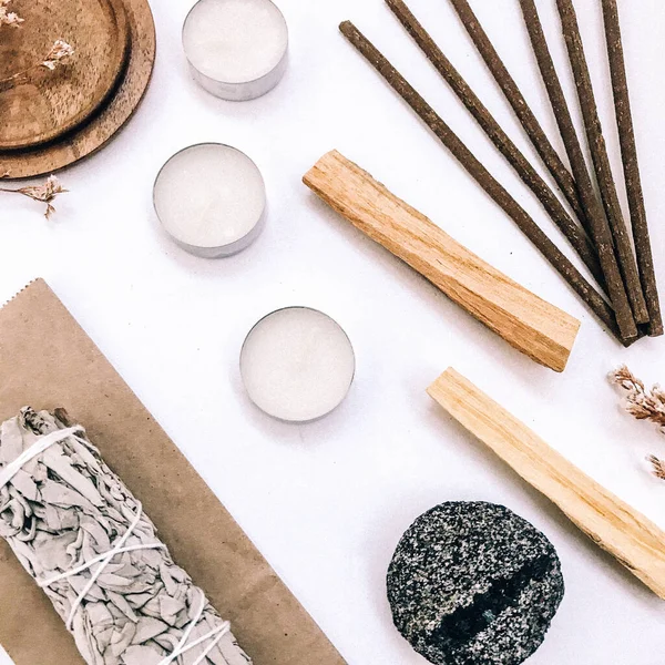 Natural incense White Sage and Palo Santo. Sacred tree of South America, color square photo.White Sage and Palo Santo on white background.