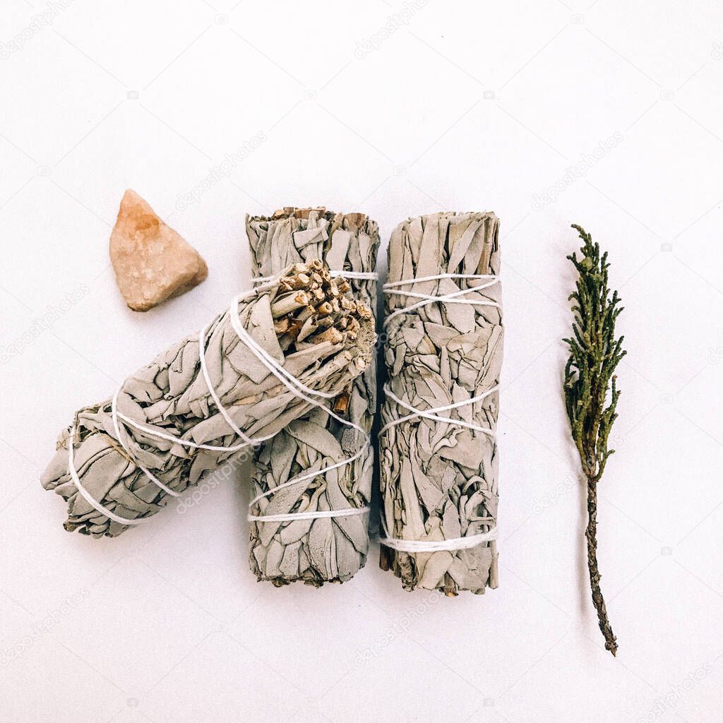 Natural incense White Sage and Palo Santo. Sacred tree of South America, color square photo.White Sage and Palo Santo on white background. 