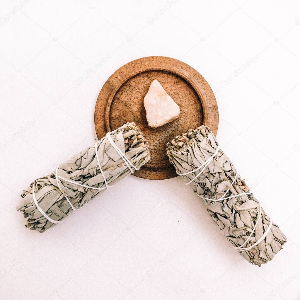 Natural incense White Sage and Palo Santo. Sacred tree of South America, color square photo.White Sage and Palo Santo on white background. 