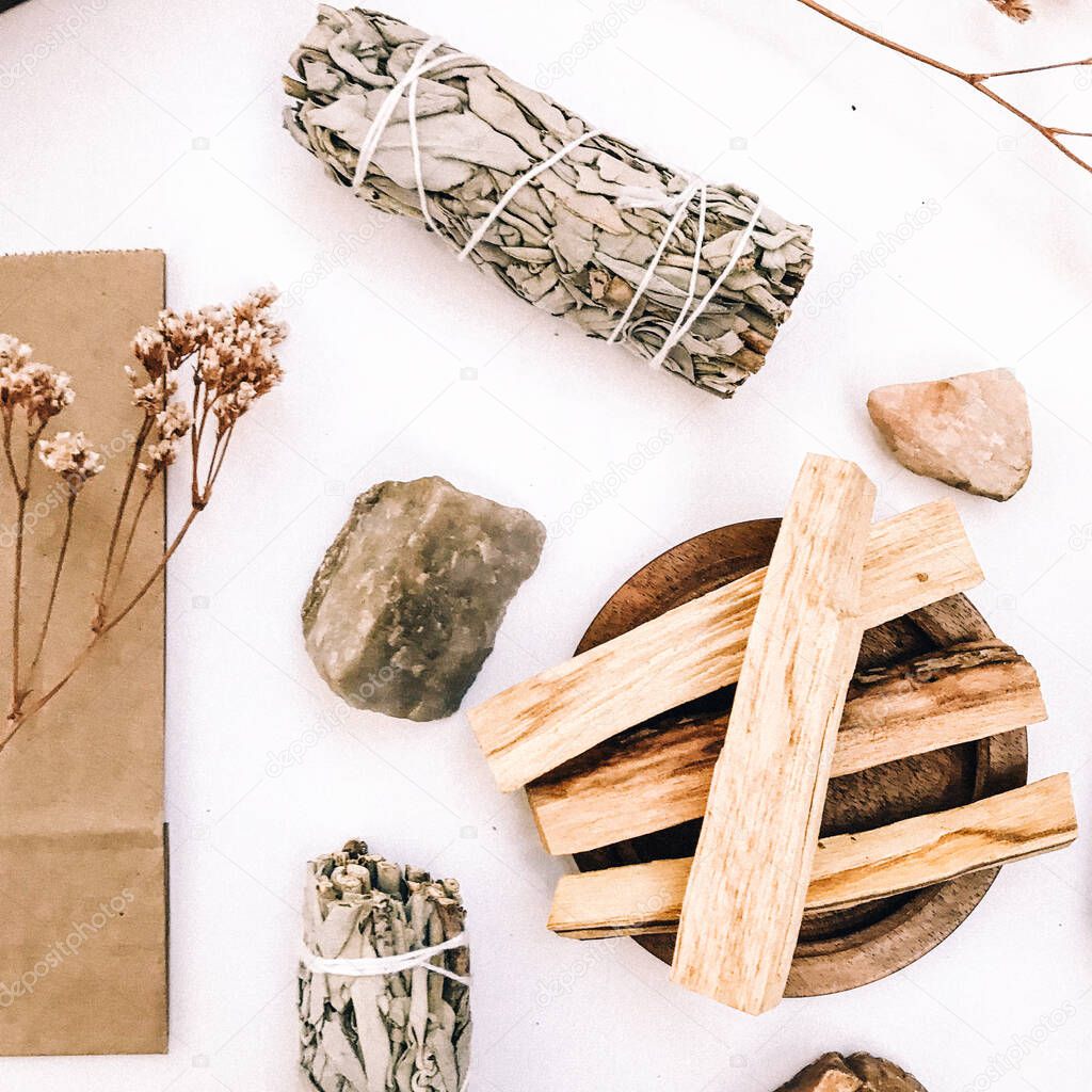 Natural incense White Sage and Palo Santo. Sacred tree of South America, color square photo.White Sage and Palo Santo on white background. 