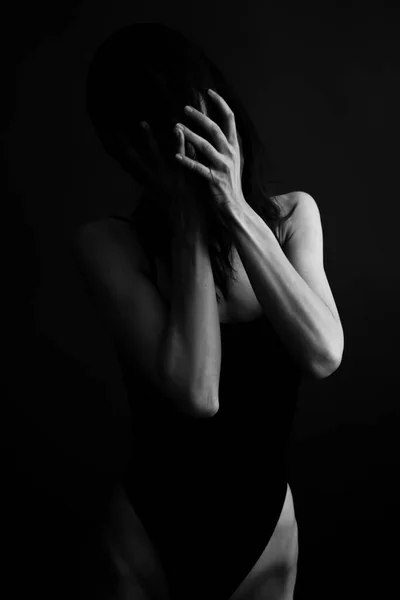 black and white photo of a person, dancer posing in studio, parts of the body, art and fashion
