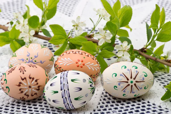 Painted Easter eggs with a twig on the desk — Stock Photo, Image