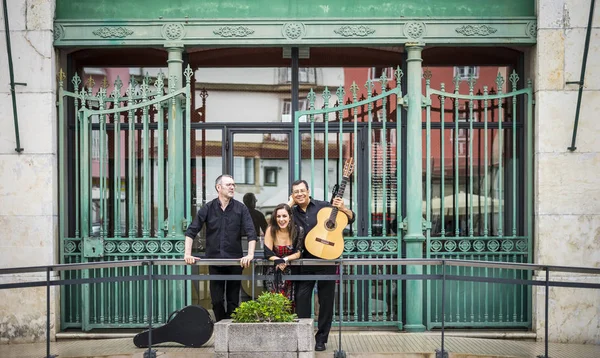 Portuguese guitar player, fado singer and acoustic guitar player in front of Fado Museum in Lisbon, Portugal