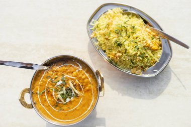 Delicious Indian food - tarka dal and egg rice on the table clipart