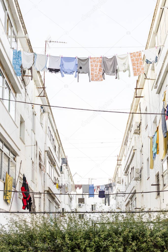 Washed clothes hanging between residencial buildings in Ayamonte, Andalusia, Spain 