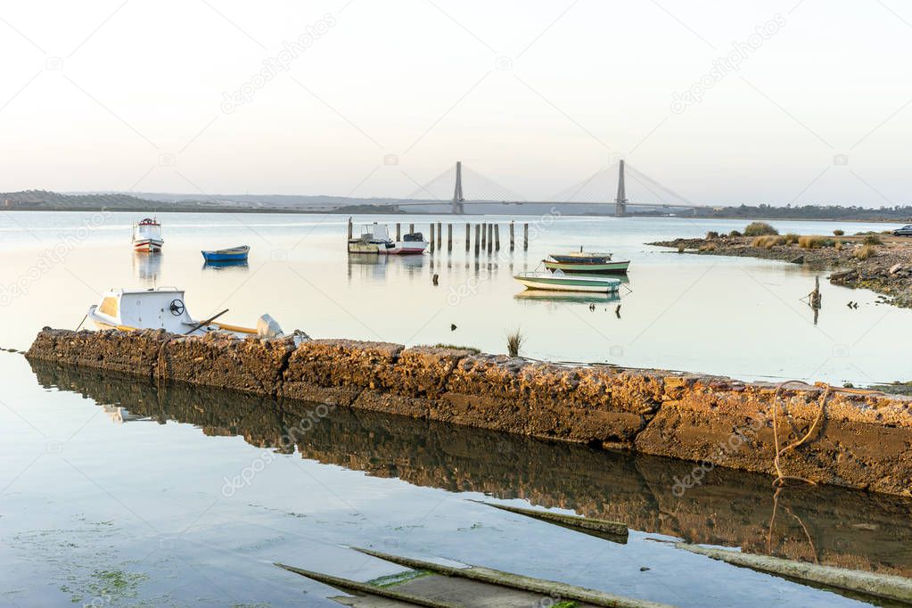 Boats and bridge over Guadiana river which is a border between S